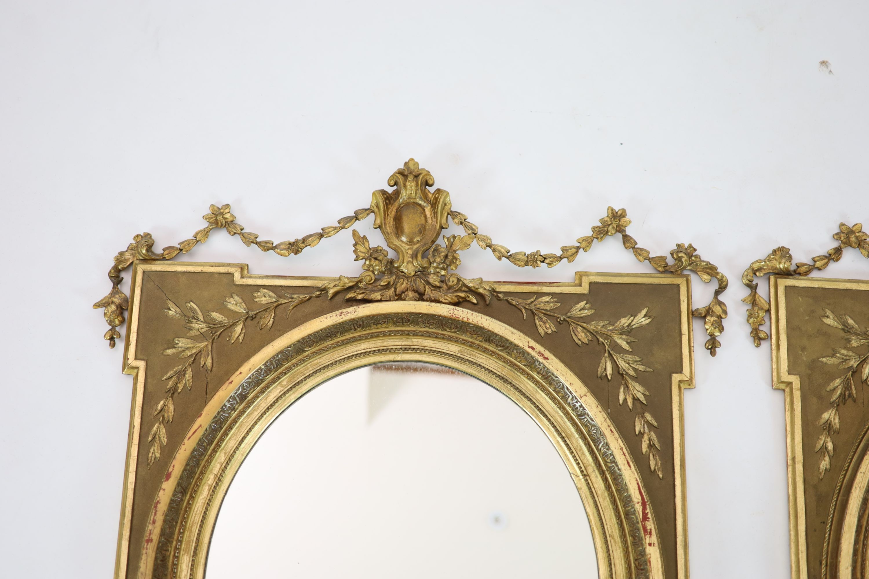 A pair of giltwood wall mirrors, of square form with oval plates, width 85cm, height 98cm